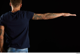 Claudio  1 arm back view blue t shirt clothing…